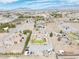 An aerial view shows a house with a pool, ample parking, desert landscaping, and mountain backdrop at 1131 China St, Pahrump, NV 89048