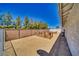 Backyard featuring two raised garden beds, gravel ground covering, and a tall, sturdy fence surrounding the property at 1131 China St, Pahrump, NV 89048