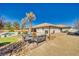 Backyard area with desert landscaping, a covered patio, built-in grill, and outdoor furniture at 1131 China St, Pahrump, NV 89048