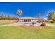Beautifully landscaped backyard with artificial turf, desert landscaping, a built-in pool, and a covered patio at 1131 China St, Pahrump, NV 89048