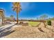 Expansive backyard featuring desert landscaping, artificial turf, and a covered patio area, perfect for outdoor living at 1131 China St, Pahrump, NV 89048