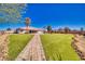 Sprawling backyard with artificial turf, beautiful pavers and mature trees that offers endless possibilities for outdoor living at 1131 China St, Pahrump, NV 89048