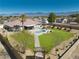 Backyard featuring a refreshing pool, manicured faux lawn, and desert landscaping, perfect for relaxation and entertainment at 1131 China St, Pahrump, NV 89048