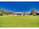 Expansive backyard with artificial lawn and desert landscaping, mature trees, offering space for outdoor activities at 1131 China St, Pahrump, NV 89048
