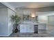 Wet bar features white cabinets, shelving, and a stainless steel mini fridge at 1131 China St, Pahrump, NV 89048