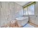 Bathroom showcasing the modern standalone tub, decorative wall hangings, and modern hardware at 1131 China St, Pahrump, NV 89048