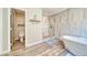 Bright bathroom with a marbled accent wall, modern walk-in shower, and separate water closet at 1131 China St, Pahrump, NV 89048