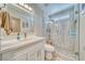 Modern bathroom with glass enclosed shower and stone tile, white vanity and modern fixtures at 1131 China St, Pahrump, NV 89048