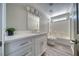 Bathroom featuring quartz countertop sink vanity and a tub shower with white tiled walls at 1131 China St, Pahrump, NV 89048