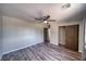 Bedroom featuring wood flooring, a ceiling fan and a closet with sliding doors at 1131 China St, Pahrump, NV 89048