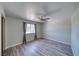 Bedroom features wood flooring, ceiling fan and a window with natural light at 1131 China St, Pahrump, NV 89048