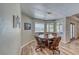 Bright dining area features an octagonal wooden table, chair set, and natural light from large windows at 1131 China St, Pahrump, NV 89048