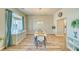Elegant dining room with wood-look floors, natural light, and stylish decor for Gathering meals and entertaining at 1131 China St, Pahrump, NV 89048