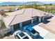 An aerial view shows a house with a tile roof and a three-car garage with a large driveway at 1131 China St, Pahrump, NV 89048