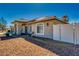 Inviting single-story home with arched entryway, well-kept landscaping, and a white fence, enhancing curb appeal at 1131 China St, Pahrump, NV 89048
