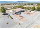 Single-story home showcases desert landscaping, large driveway and an RV parked on the side at 1131 China St, Pahrump, NV 89048