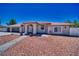 Charming single-story home featuring a desert landscape, covered entryway, and a spacious three-car garage at 1131 China St, Pahrump, NV 89048