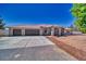 Charming single-story home featuring a desert landscape, a long driveway, and a spacious three-car garage at 1131 China St, Pahrump, NV 89048
