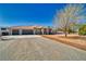 Inviting single-story home featuring a desert landscape, three-car garage, and a neatly maintained driveway at 1131 China St, Pahrump, NV 89048