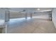 Spacious three car garage with overhead door openers, finished floor, and ample storage space at 1131 China St, Pahrump, NV 89048