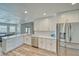 Bright, airy kitchen features white cabinetry, stainless steel appliances, quartz countertops, and backyard views at 1131 China St, Pahrump, NV 89048