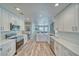 Bright, airy kitchen features white cabinetry, stainless steel appliances, quartz countertops, and backyard views at 1131 China St, Pahrump, NV 89048