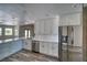 Bright kitchen with quartz countertops, stainless steel appliances, white cabinets, and ample counter space at 1131 China St, Pahrump, NV 89048