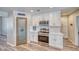 Bright kitchen features white cabinetry, stainless steel appliances, quartz countertops, and a pantry at 1131 China St, Pahrump, NV 89048
