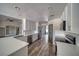 Modern kitchen with white cabinets, quartz countertops, stainless steel appliances, and wood-look floors at 1131 China St, Pahrump, NV 89048