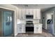 Well-equipped kitchen area featuring stainless steel appliances, white cabinets, and quartz countertops at 1131 China St, Pahrump, NV 89048