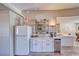 Bright kitchen featuring white cabinetry, stainless steel mini-fridge, and coffee bar setup at 1131 China St, Pahrump, NV 89048