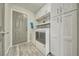 Spacious laundry room with washer, dryer, built in cabinets, and hardwood style flooring at 1131 China St, Pahrump, NV 89048