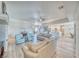 Open-concept living room with wood-look floors, a ceiling fan, and seamless flow into the kitchen area at 1131 China St, Pahrump, NV 89048