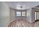Inviting living room with wood-look floors, large windows providing views of the outdoor pool and patio at 1131 China St, Pahrump, NV 89048