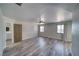 Spacious main bedroom with wood-look floors, ceiling fan, two windows, and an attached bathroom with dual sink vanity at 1131 China St, Pahrump, NV 89048