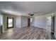 Large main bedroom with wood-look floors, ceiling fan, and doors leading to the outside patio and the main bathroom at 1131 China St, Pahrump, NV 89048