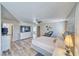Bright main bedroom featuring hardwood floors, a ceiling fan, and a flat screen television at 1131 China St, Pahrump, NV 89048