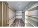 Walk-in closet with shelving and wood-look floors, offering ample space for clothing and accessories at 1131 China St, Pahrump, NV 89048