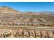 Expansive aerial view of a community showcasing well-planned streets, homes, and mountain views at 11826 Corenzio Ave, Las Vegas, NV 89138