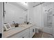 Bright bathroom with a double sink vanity, white cabinets, and a shower/tub combo with curtain at 11826 Corenzio Ave, Las Vegas, NV 89138