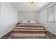 Cozy bedroom showcasing neutral walls, plush bedding, and bright natural light at 11826 Corenzio Ave, Las Vegas, NV 89138