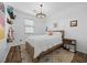 Inviting bedroom with a cozy bed, soft lighting, and charming decor, perfect for relaxation at 11826 Corenzio Ave, Las Vegas, NV 89138