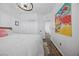 Bright bedroom featuring a modern chandelier, white walls, and wood-look flooring at 11826 Corenzio Ave, Las Vegas, NV 89138
