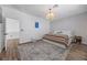 Bright bedroom features wood floors, a patterned rug, and a stylish light fixture at 11826 Corenzio Ave, Las Vegas, NV 89138