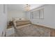 Inviting bedroom features wood floors, patterned accent wall and lots of natural light at 11826 Corenzio Ave, Las Vegas, NV 89138