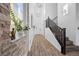Elegant entryway featuring a modern staircase, stylish light fixtures, and attractive interior design elements at 11826 Corenzio Ave, Las Vegas, NV 89138