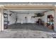 Attached two-car garage with overhead storage, shelving, and interior access door at 11826 Corenzio Ave, Las Vegas, NV 89138
