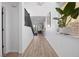Bright hallway with wood floors, modern staircase, and natural light enhancing the welcoming ambiance at 11826 Corenzio Ave, Las Vegas, NV 89138