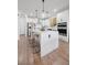 Contemporary kitchen features a center island, stainless appliances, and stylish pendant lighting at 11826 Corenzio Ave, Las Vegas, NV 89138