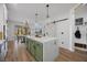 Spacious kitchen features a large island, modern lighting, and access to the outdoor area at 11826 Corenzio Ave, Las Vegas, NV 89138